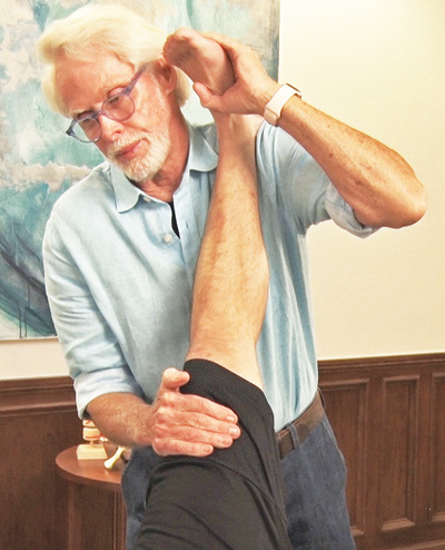 Image 5. I apply a basic hamstring stretching technique to address the client’s chronic hamstring injury and to relieve posterior drag of the biceps femoris tendon on his fibula