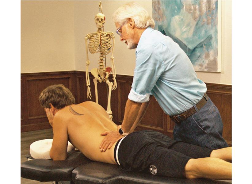 Image 3. Sphinx Hyperextension Test: The client assumes a pain-free sphinx position and the therapist's soft palms apply very gentle pressure to each side of the lumbar spine. Record as positive for possible Z-joint pathology if the client reports localized low-back or gluteal pain.